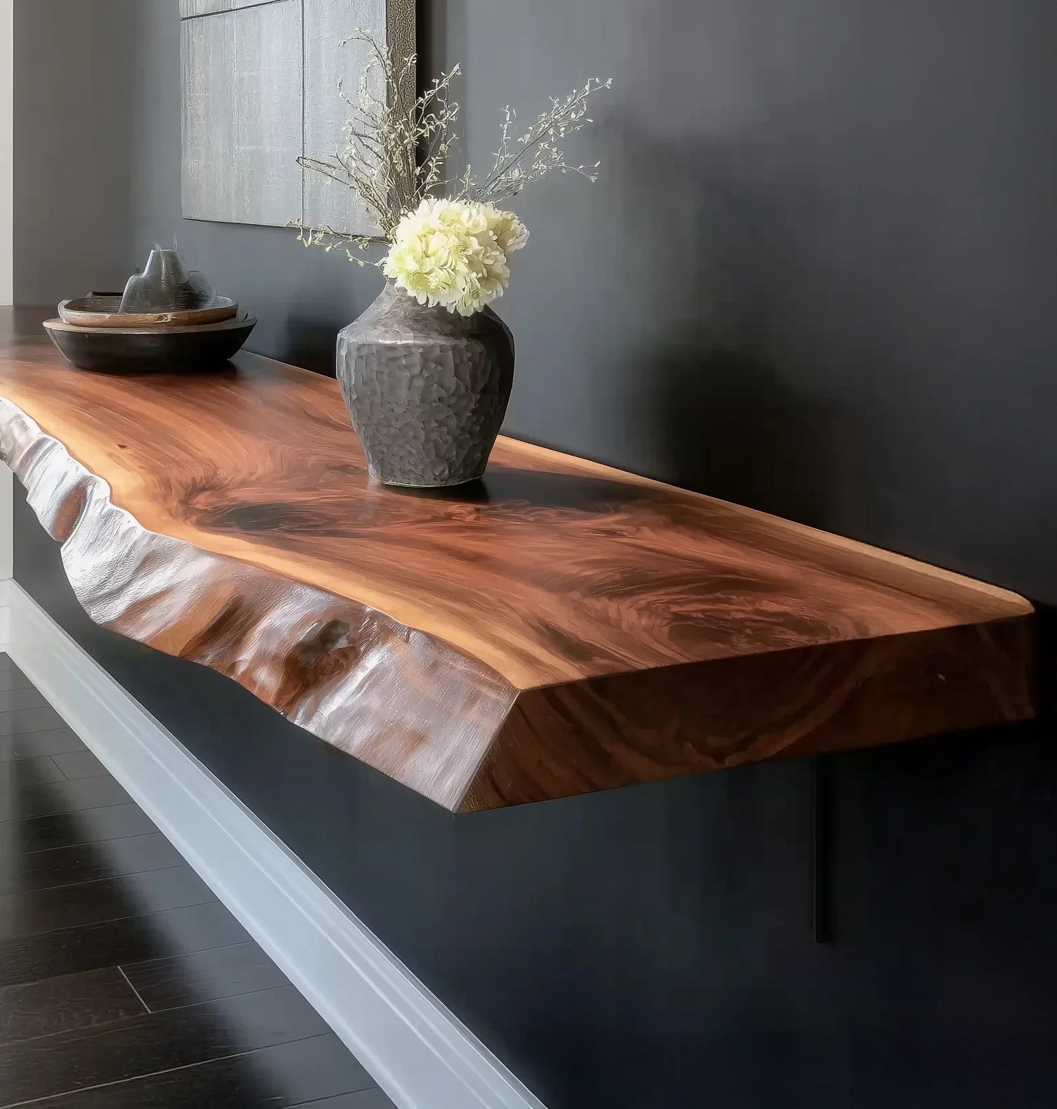 Live edge wood floating shelf with decorative vase and bowl against dark wall