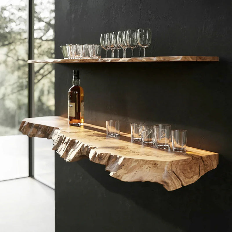Live edge floating wood shelves on black wall, with glassware and bottle displayed.