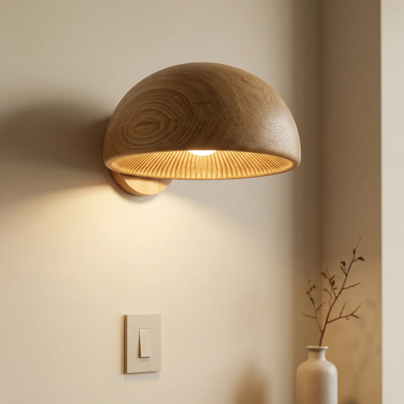 Minimalist dome mushroom wall sconce with solid wood half-sphere design, illuminated on wall