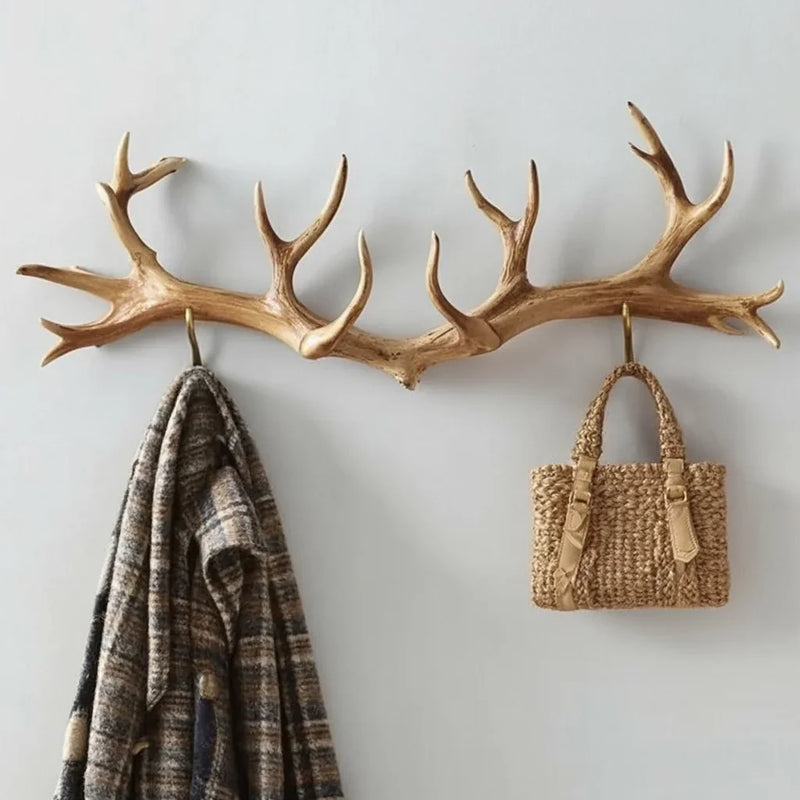 Antler-shaped wooden wall hook rack with a blanket and woven bag hanging