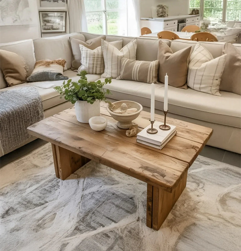 handcrafted wood coffee table in bohemian living room with layered rugs
