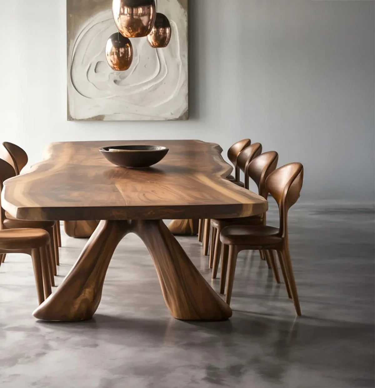 Modern dining room with live edge wooden table, matching chairs, copper pendant lights, and abstract wall art