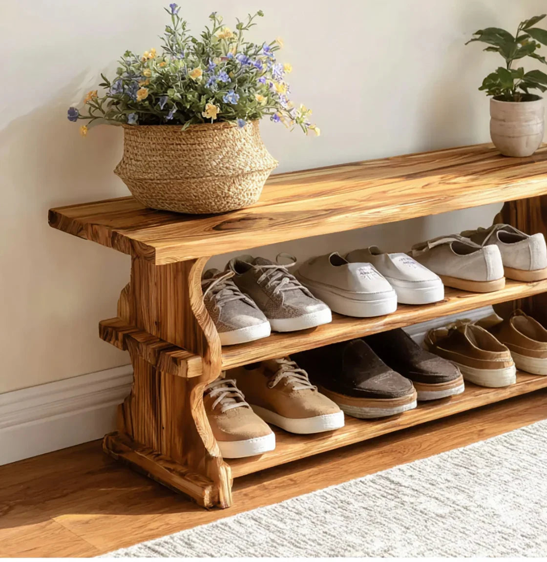 Solid wood shoe rack bench with live edge design, displaying shoes and potted plants in entryway