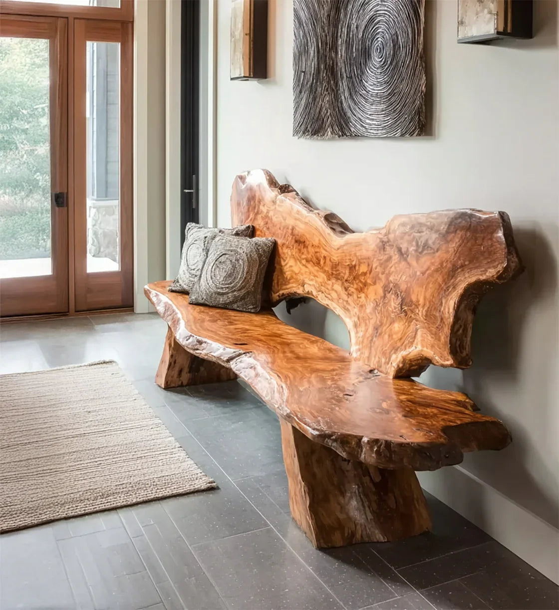 Rustic natural wood bench with textured gray cushions in modern entryway with stone tile floor