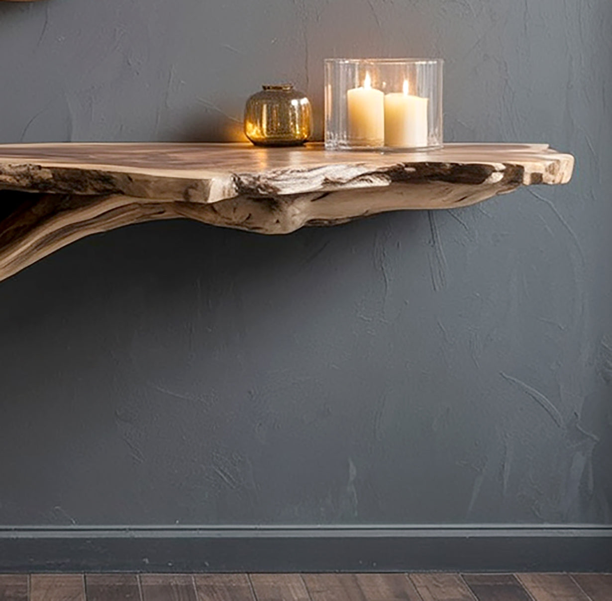 Rustic live edge wooden wall shelf with two lit candles in glass holder and a small golden vase