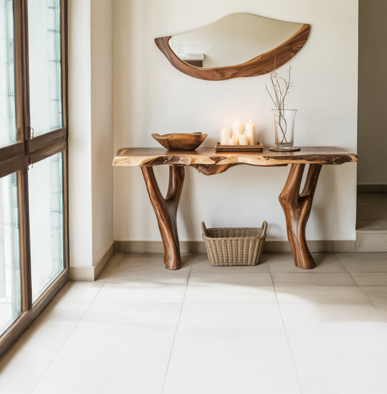 Rustic wooden console table with natural edges, candles, bowl, and branches in a bright modern hall