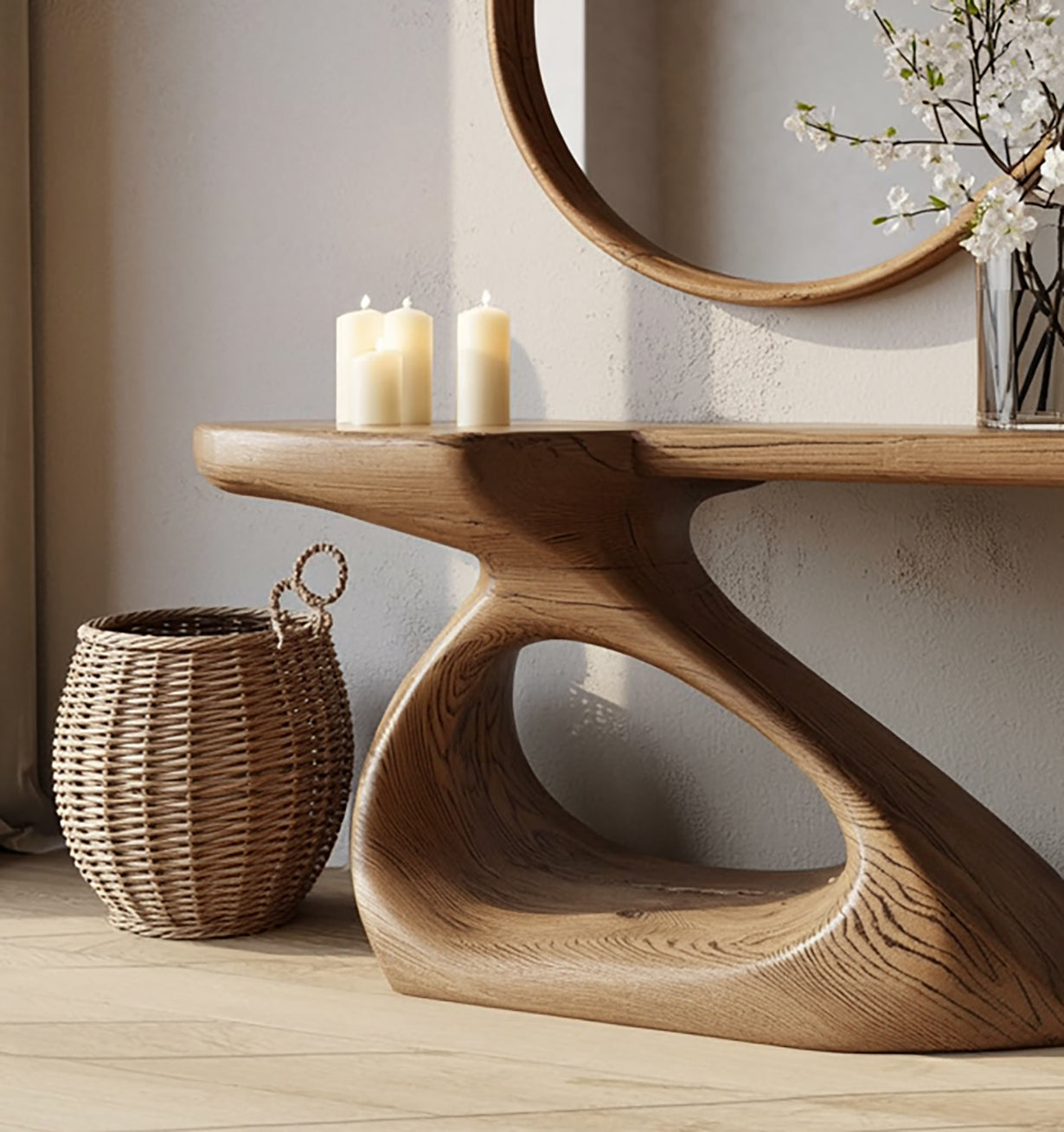 Modern wooden console table with sculptural base, lit candles, wicker basket, and round wall mirror