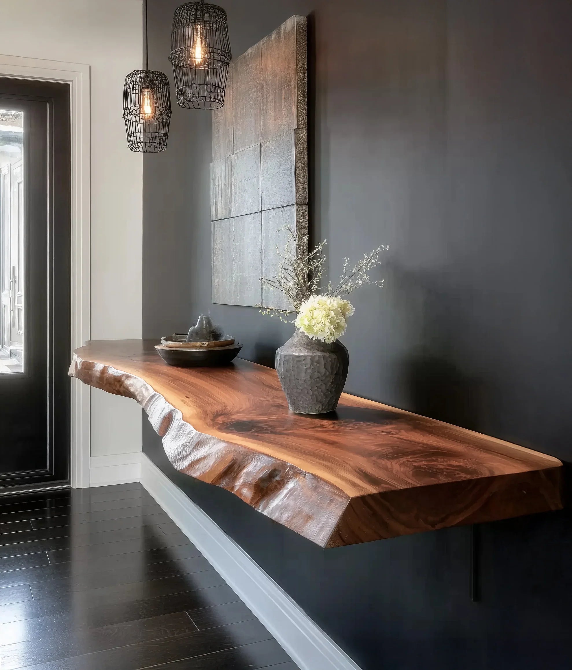 modern entryway with floating live edge wooden console table, decorative vase with flowers, and wire cage pendant lights