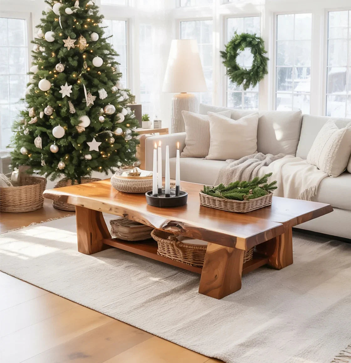 Cozy living room with decorated Christmas tree, wooden coffee table with candles and greenery, and beige sofa
