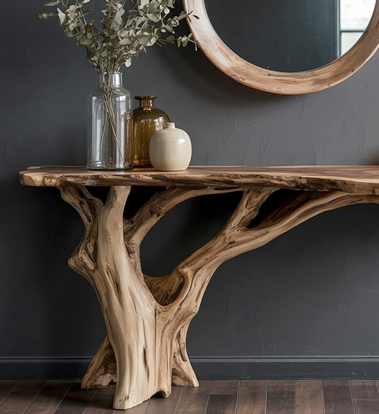 Modern wooden console table with natural tree branch legs against dark wall with round mirror and decorative vases