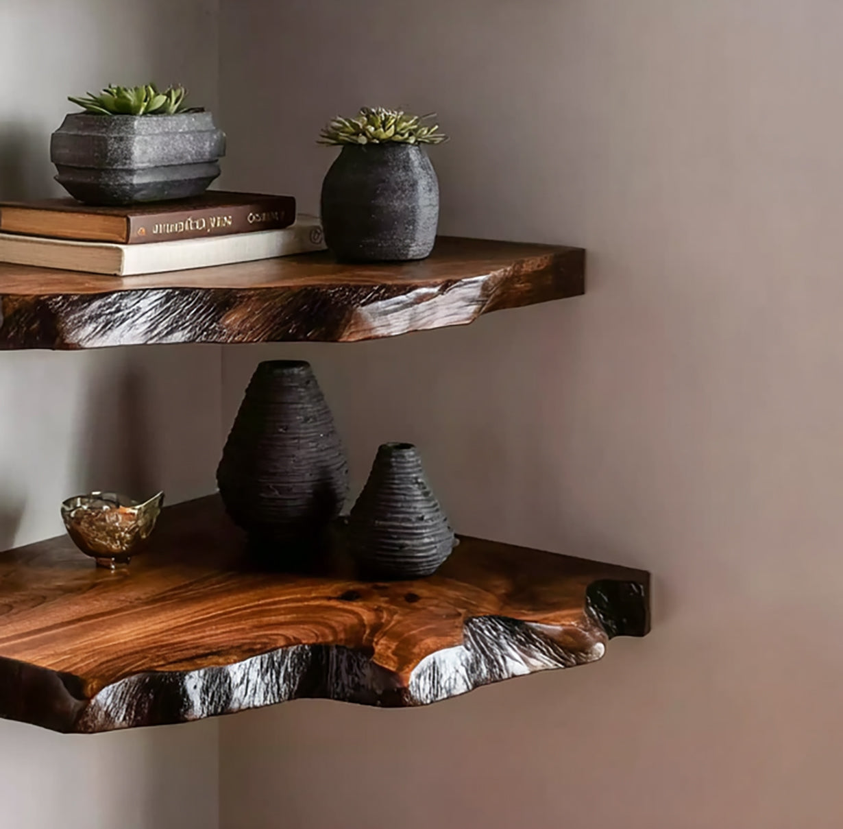Live edge solid wood floating shelves with ceramic vases, books, and succulents