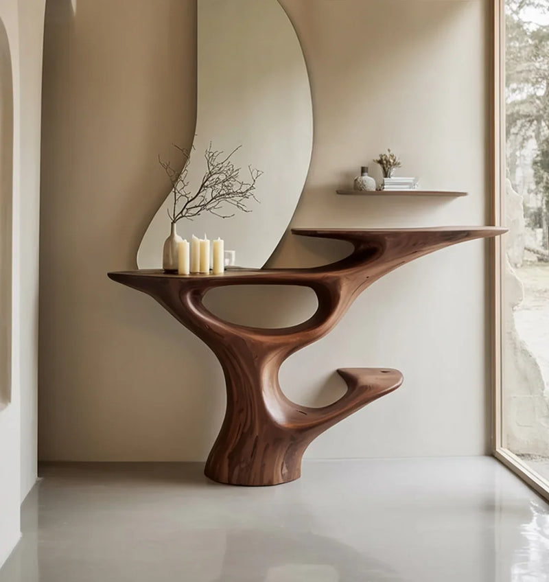 Sculptural live edge wood console table in modern entryway with candles and vase