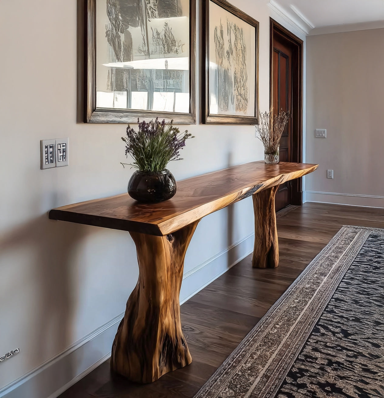 Hallway with live edge wooden console table, floral vases, framed abstract art, and patterned rug