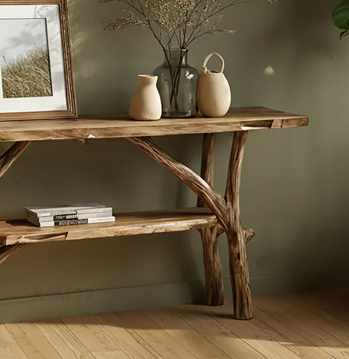 Rustic wooden console table with natural branch legs, decorative vases, and framed art in cozy room