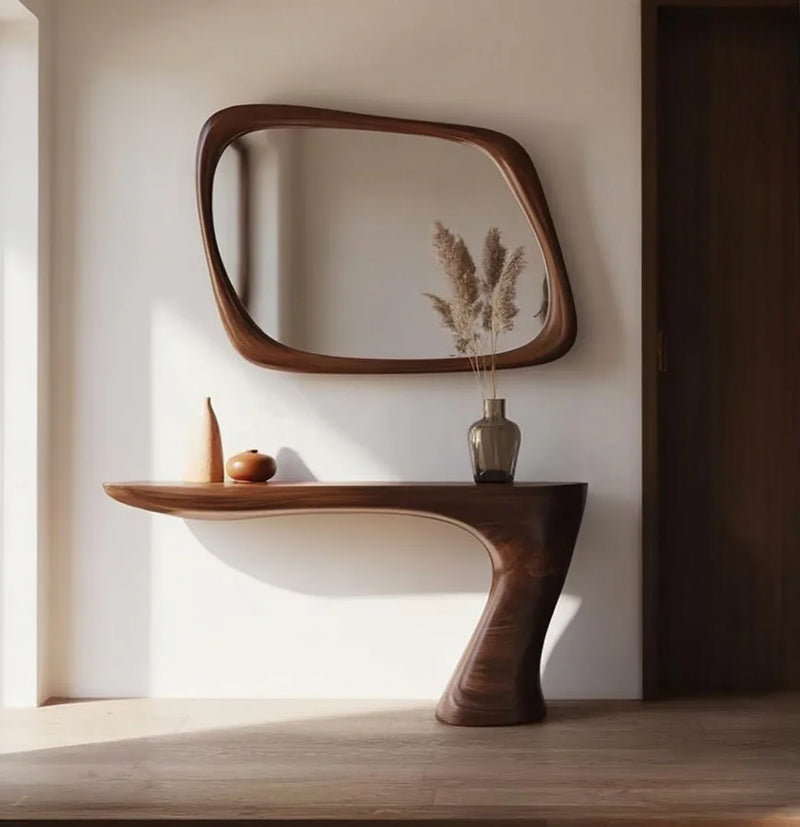 Modern wooden console table with matching irregular mirror and decorative vases with pampas grass