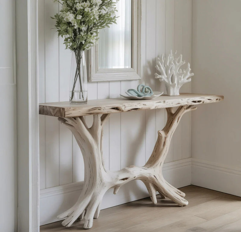 Live edge wood console table with tree branch legs, vase with flowers, coastal decor