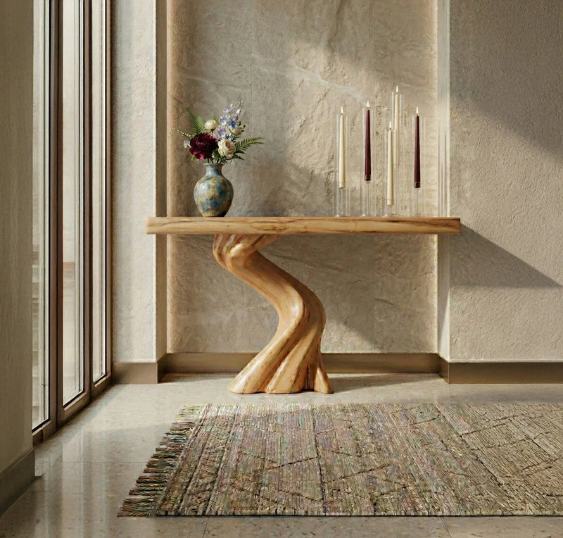 Live edge solid wood entryway table with twisted base, vase of flowers, and tall candles