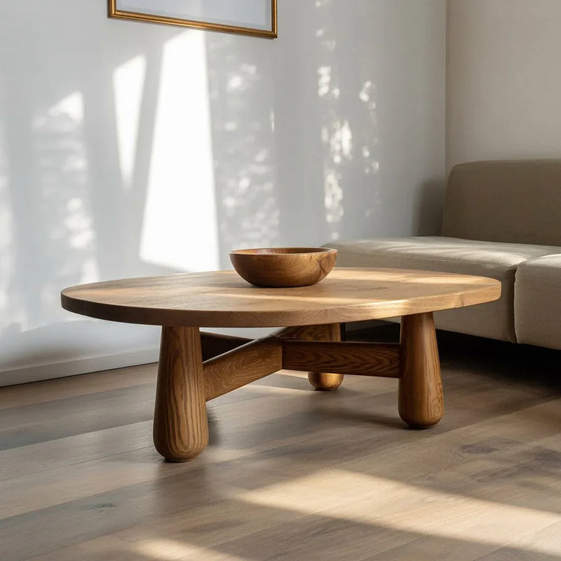 Solid wood coffee table with rounded legs and wood bowl in modern living room