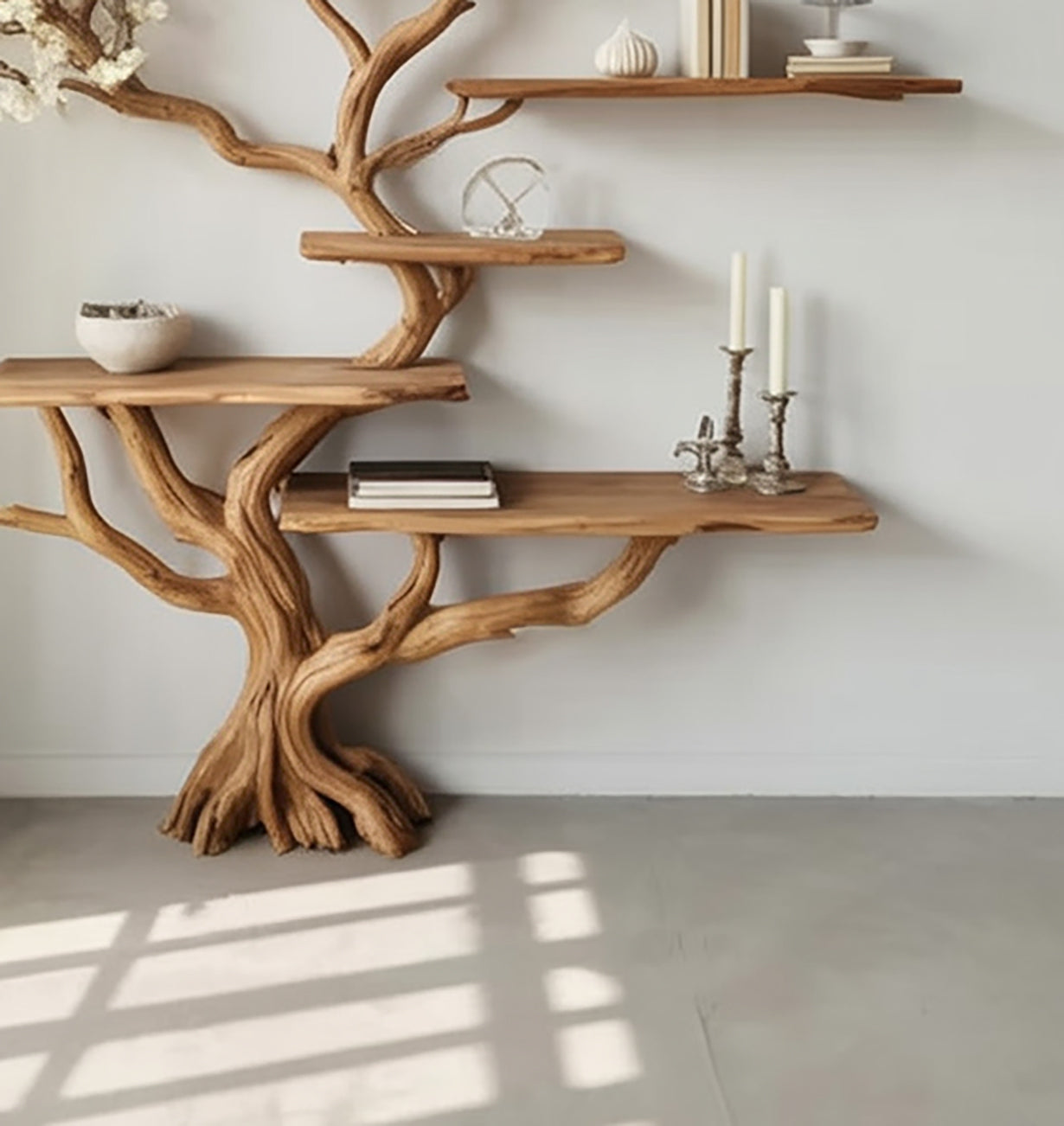 Solid wood tree bookshelf with live edge floating shelves against a white wall.