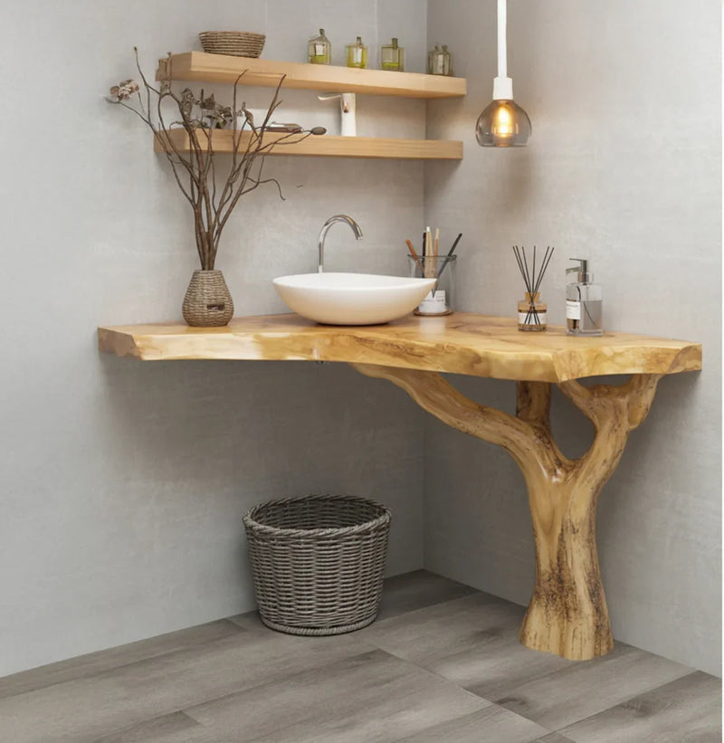 Live edge wood bathroom vanity with tree-shaped base, vessel sink, and floating shelves.