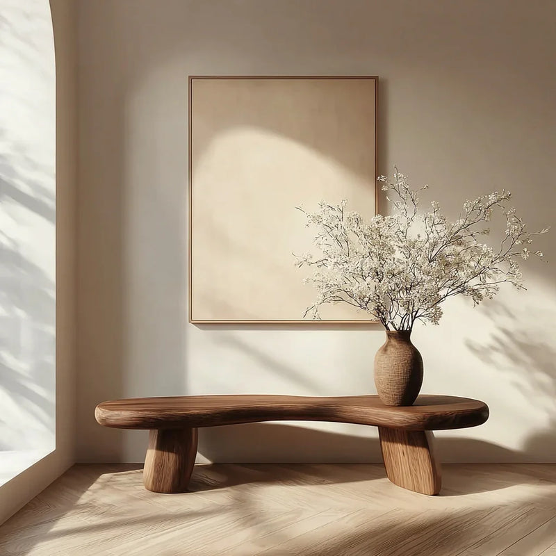Minimalist modern interior with wooden bench, textured ceramic vase, and dried floral arrangement