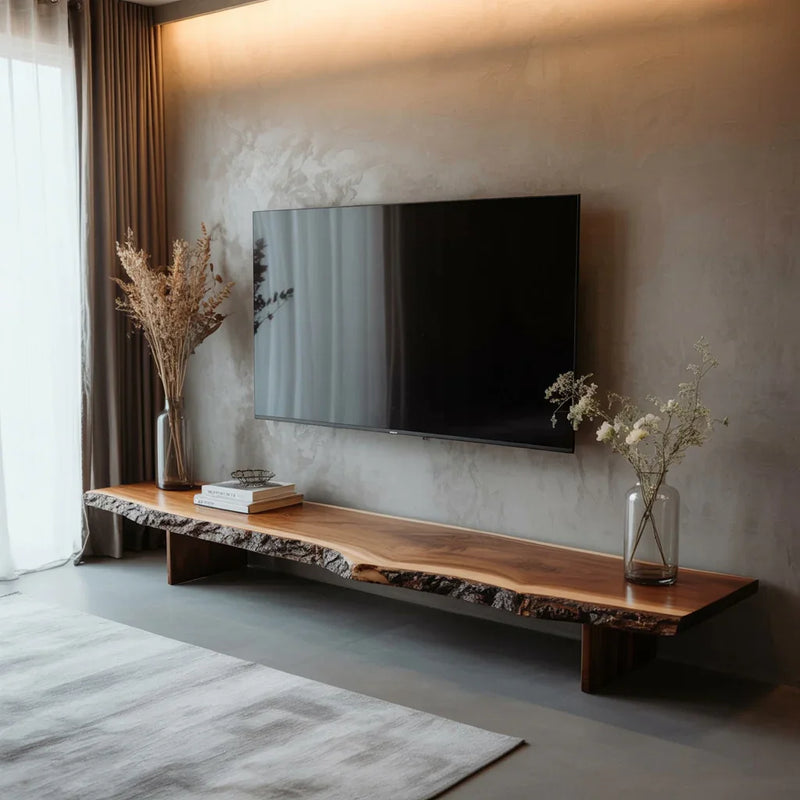 Minimalist living room with mounted flat-screen TV and live edge wooden media console with decor
