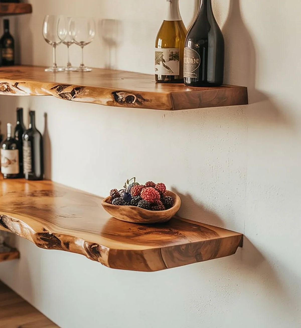Live edge solid wood floating shelves with wine bottles and a wooden fruit bowl