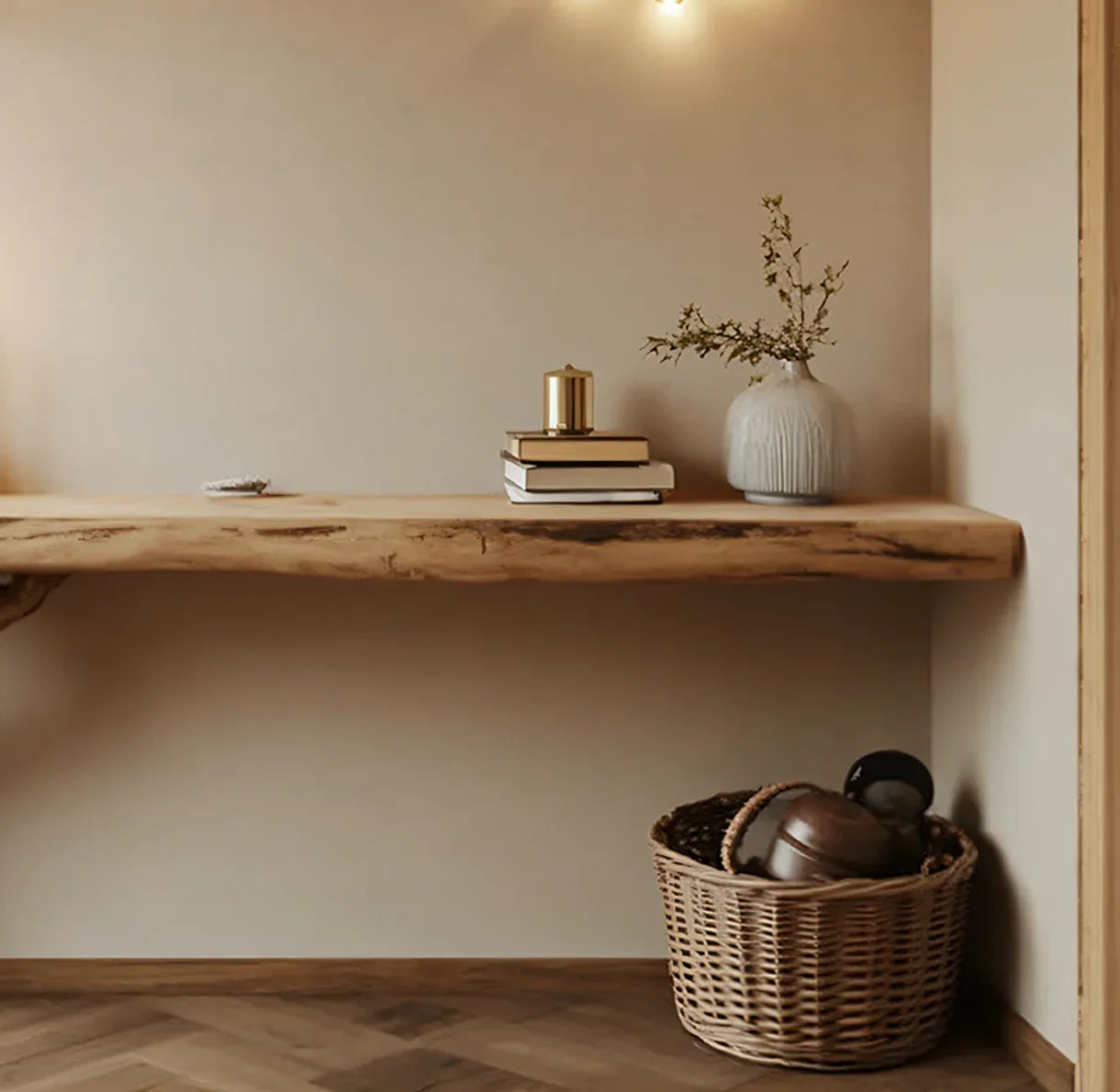 Floating live edge wood shelf with books, decorative vase, and a wicker basket below