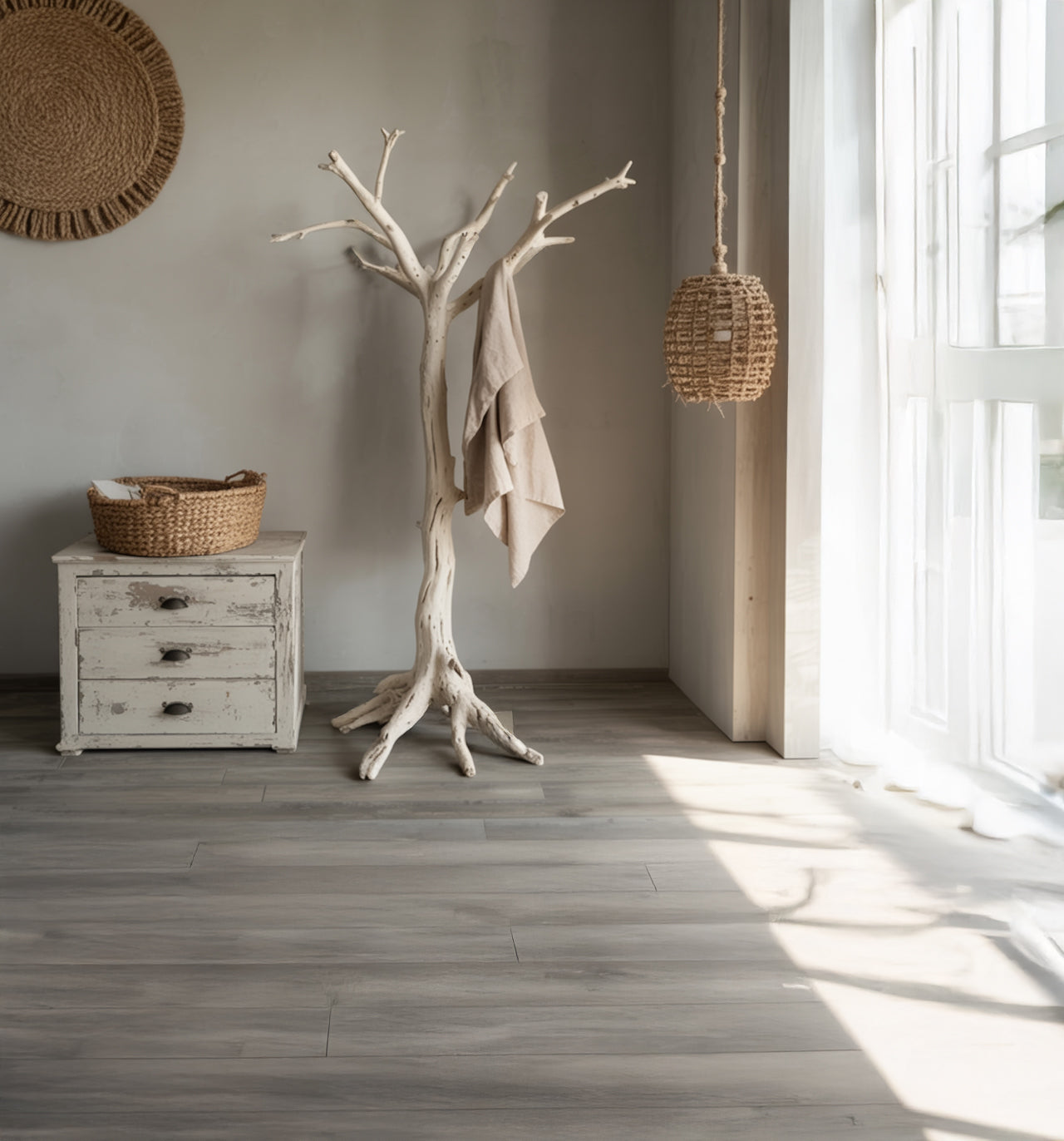 Minimalist room with white rustic dresser, woven basket, tree branch coat rack, and hanging wicker lamp
