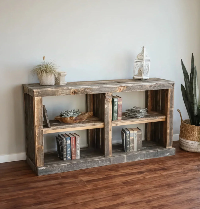 Rustic solid wood bookshelf with books, succulents, and decor, on wood floor.