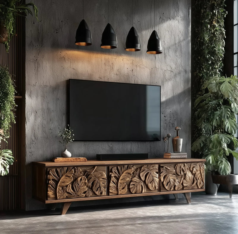 Solid wood TV console with carved leaf details in modern living room with greenery and pendant lights