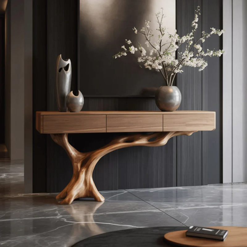 Modern solid wood entryway console table with tree branch base, decor vases, and floral arrangement.