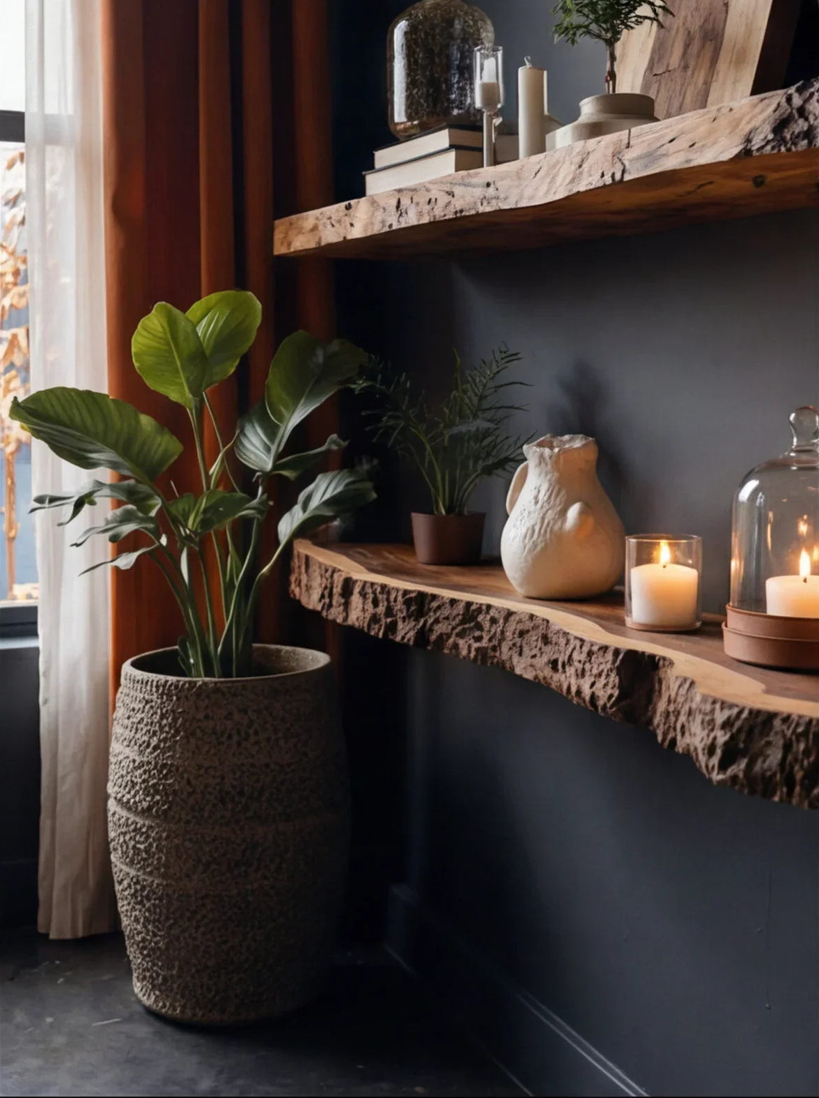 Live edge solid wood floating shelves with candles, books, plants, and decorative vase in a modern room.