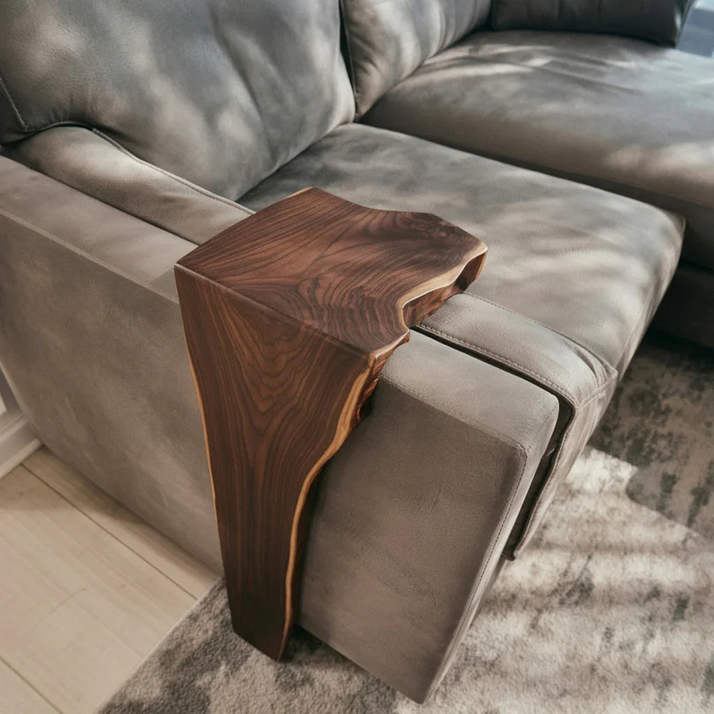 Live edge solid wood armrest tray on grey sofa, modern sustainable furniture accent