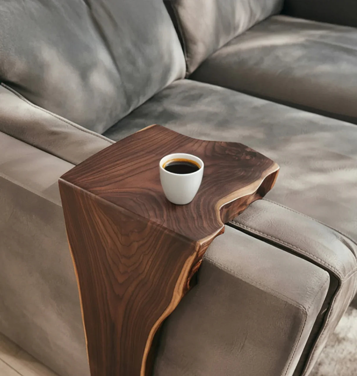 Live edge solid wood sofa arm tray with coffee cup on gray upholstered couch