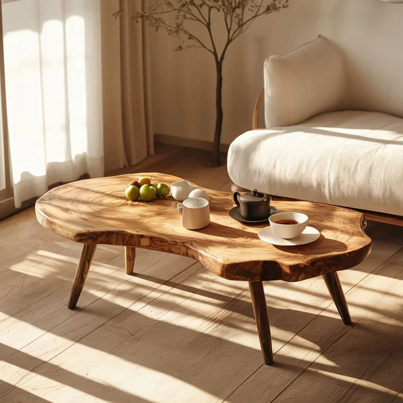 Live edge solid wood coffee table in sunlit modern living room with tea set and fruit