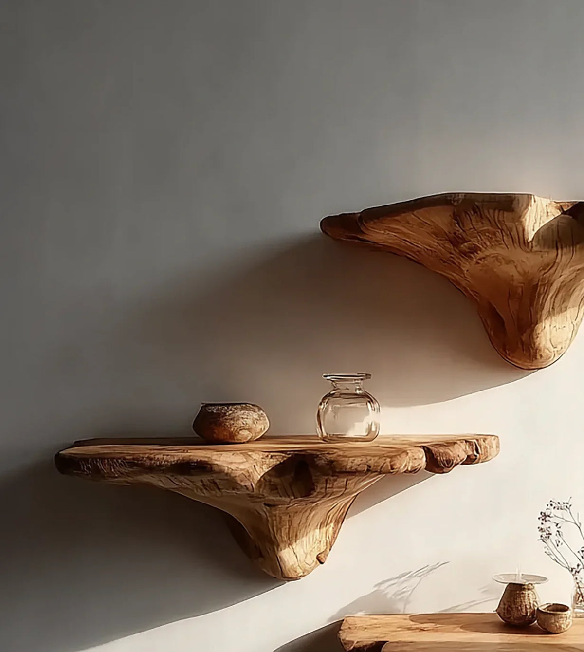 Live edge solid wood floating shelves on wall with glass and ceramic decor