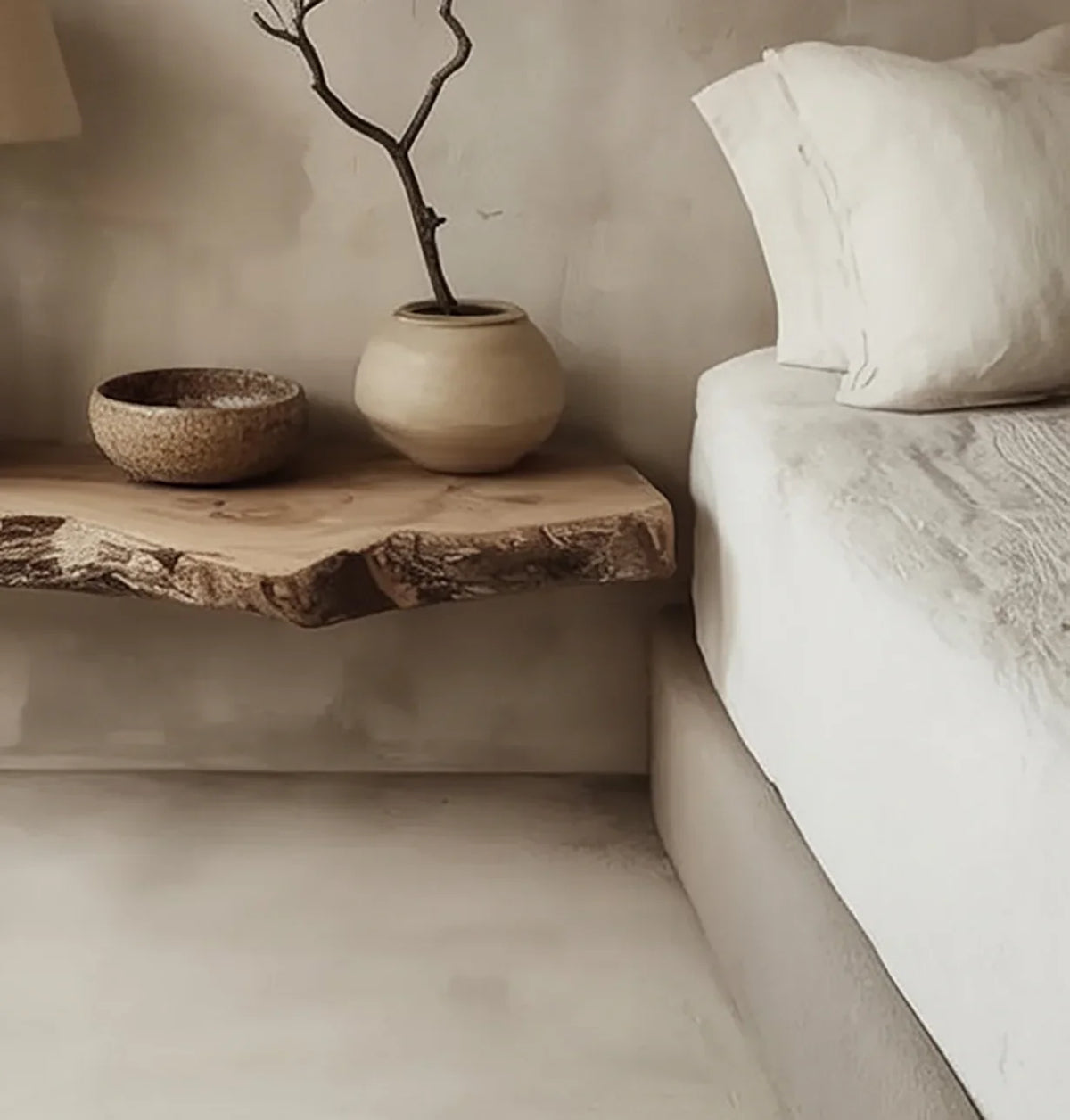 Live edge solid wood floating shelf with decorative ceramics beside a bed