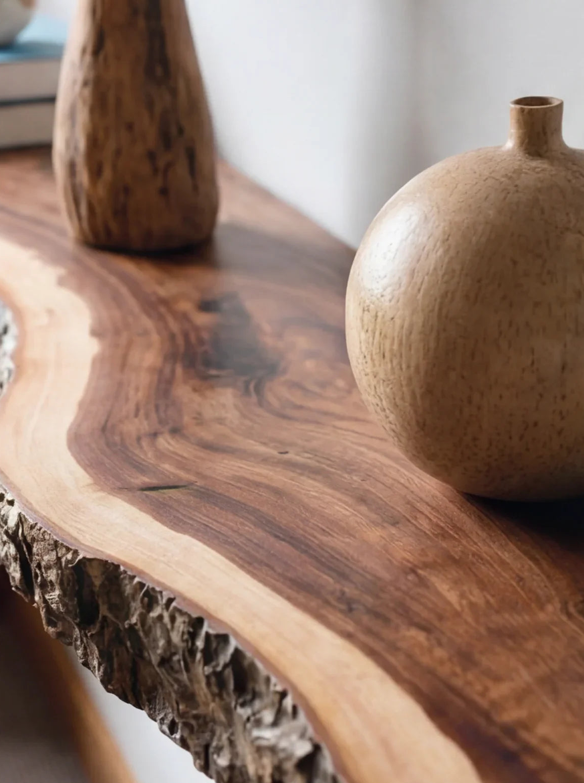 Live edge solid wood table with natural bark edge and decorative wooden vases