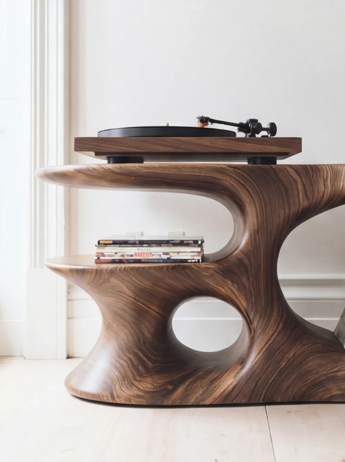Sculptural solid wood table with turntable and vinyl records, modern organic design