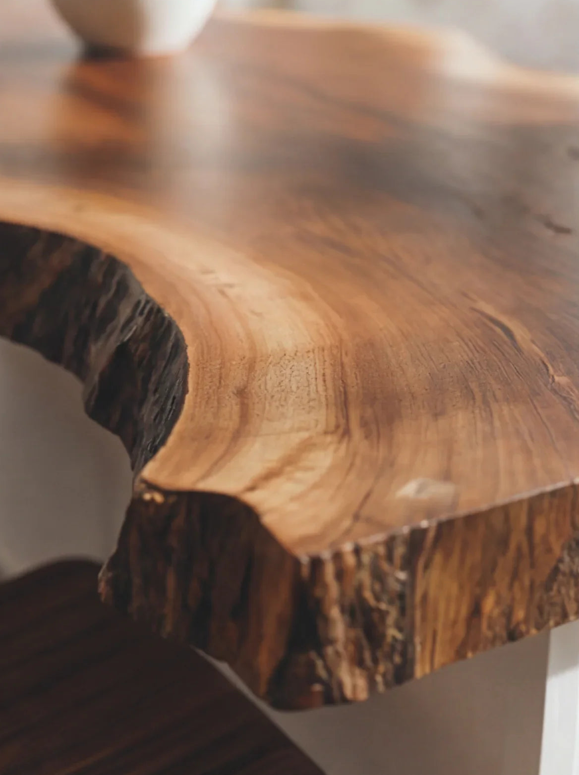 Close-up of a live edge solid wood table with natural grain and organic edge