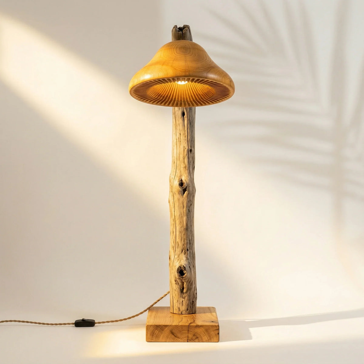 Driftwood mushroom floor lamp with solid oak base and braided cord in sunlit room