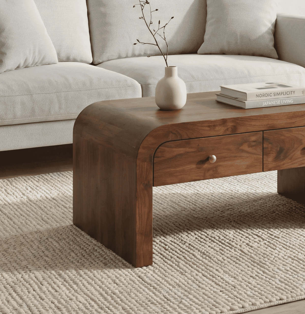 Sculptural curved coffee table crafted from solid wood with functional drawer storage