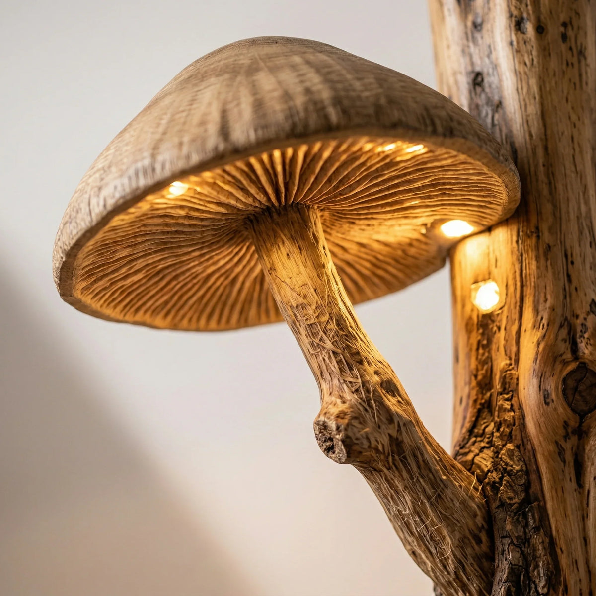 Hand-carved mushroom lamp with warm lights on natural wood tree trunk