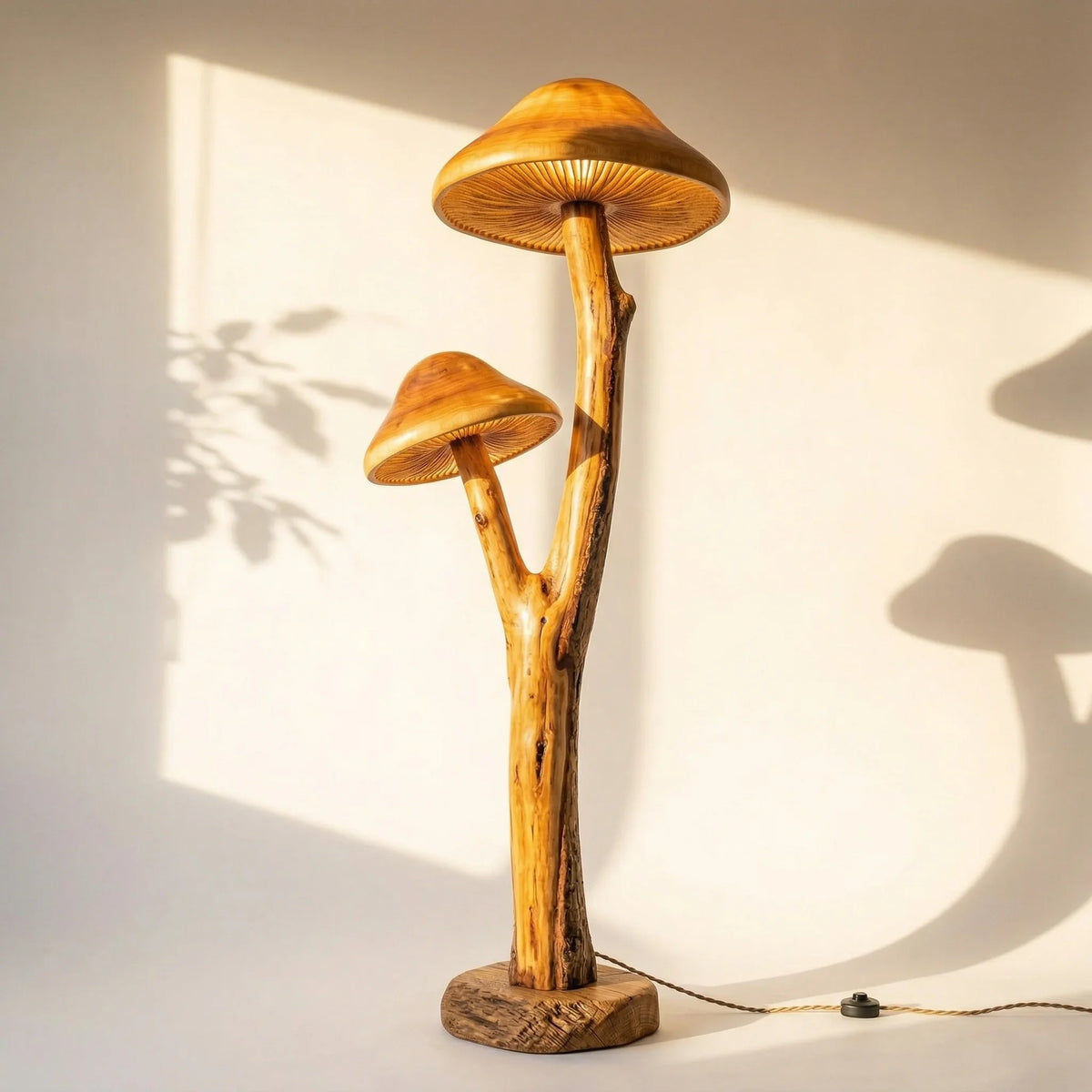 Dual mushroom-shaped floor lamp with sculpted wooden branch stem and live edge base