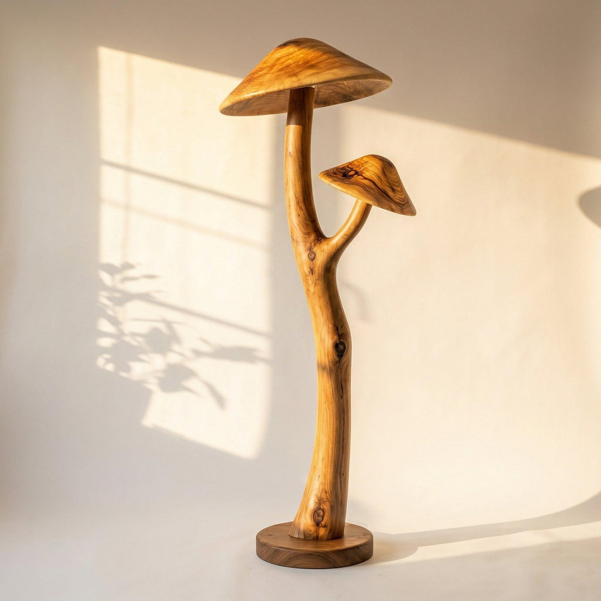 Sculpted wooden mushroom floor lamp with dual wood caps and a walnut disc base