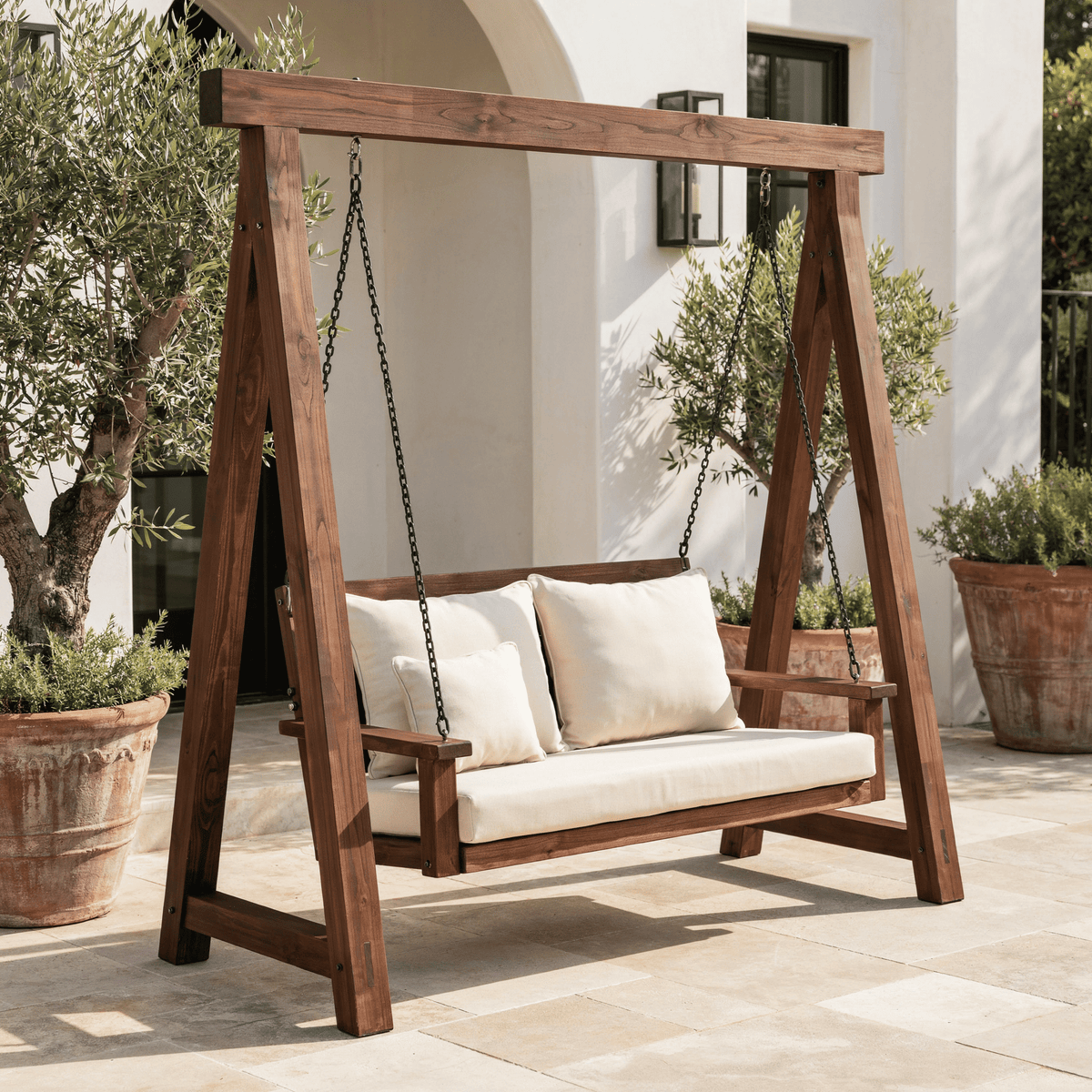 Solid wood garden glider bench styled on a charming farmhouse porch