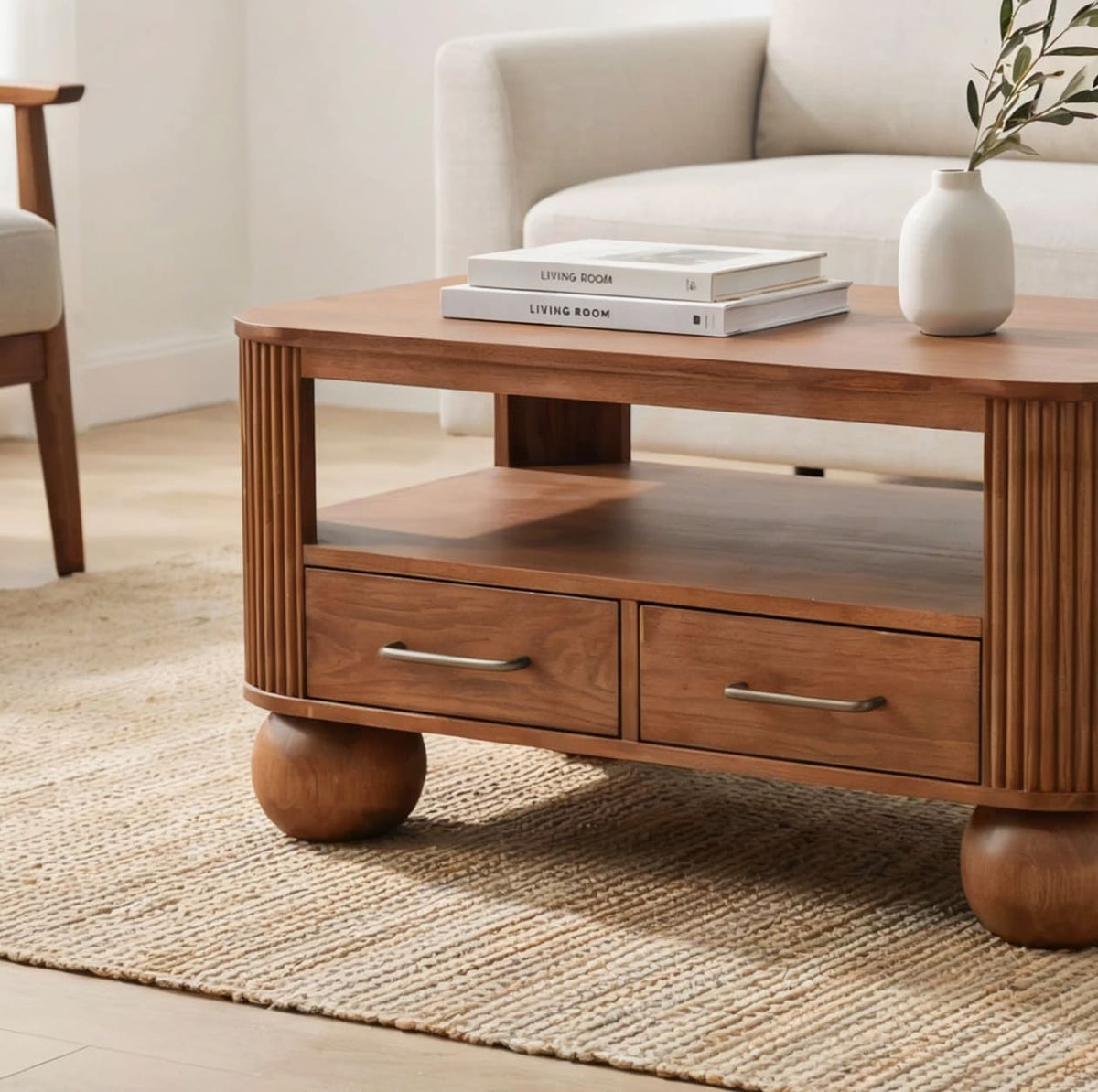 Modern fluted solid wood coffee table featuring functional storage drawers and sculptural ball feet
