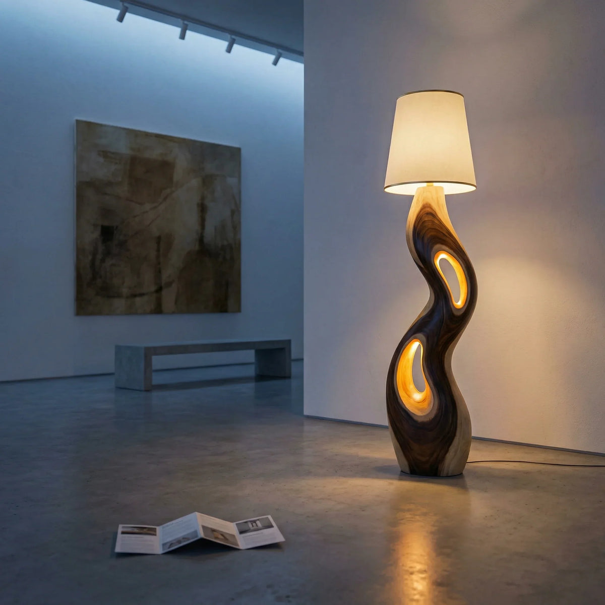 Freeform sculpted wood floor lamp with triple openings and glowing accents in modern room