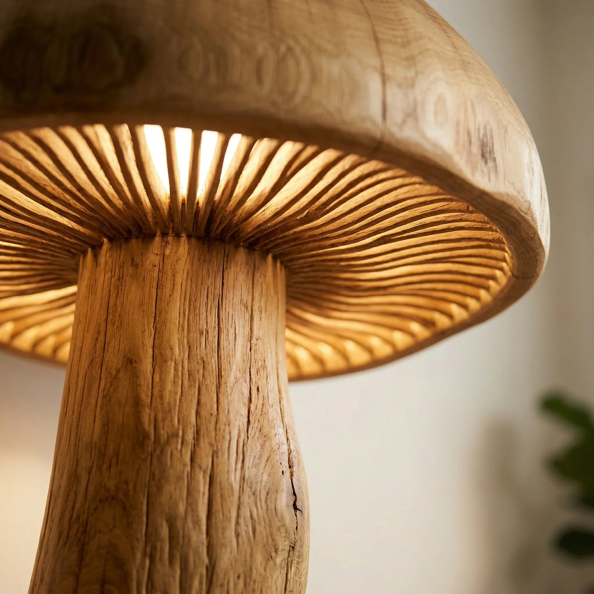 Close-up of a giant mushroom floor lamp with carved wood trunk and glowing gill detail